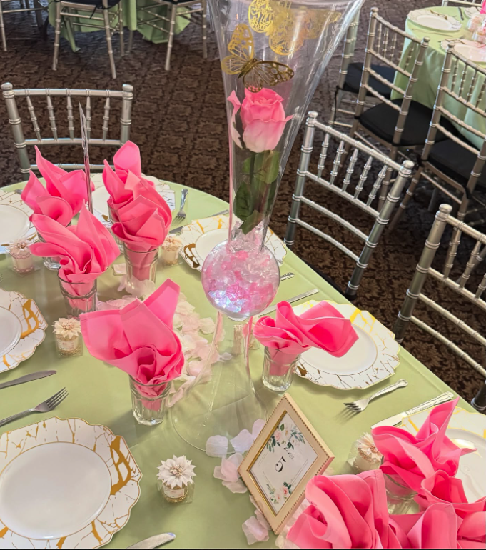 Elegant table setting with pink napkins and floral centerpieces
